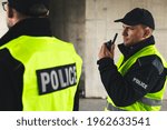 Small photo of Proud policemen speaking on the walkie-talkie, reporting to station