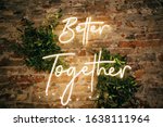 Better Together - neon sign on a brick wall in a restaurant at a wedding party. Love concept
