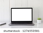 Small photo of Digital technology Laptop muck up blank white screen and flower pot book on white table ,Home interior or office background