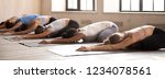 Small photo of Diverse girls energize start new day with yoga session. Sportive females lying resting on rubber mats doing Child Pose, side view. Horizontal photography banner for website header. Wellness concept