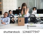 Small photo of Desperate dismissed woman holding head in hands at workplace, upset female employee pack belongings in cardboard box, feeling stressed about job loss, unexpected undeserved dismissal, discrimination