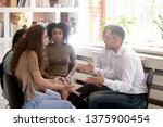 Small photo of Multiracial people sitting on chairs at group rehab share personal problems struggle with addictions, focus on nervous couple girl guy quarrelling arguing bad relations enmity misunderstanding concept