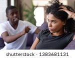 Small photo of Mad emotional African American husband blame indifferent wife for relations troubles or separation, cold black woman ignore angry dissatisfied lover or boyfriend shouting, having fight or dispute