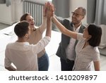 Happy motivated diverse business work team people employees group giving high five together engaged in teambuilding celebrate success good teamwork result shared win promise trust integrity concept