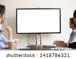 Focused business people gather at boardroom sitting at desk looking at tv white mock up with copyspace blank screen for advertisement. Seminar, presentation, corporate team at company training concept
