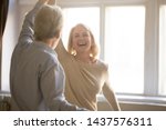 Small photo of Happy middle aged mature woman enjoying dancing with elder husband at home, active healthy senior old couple man and woman pensioners having fun in waltz laughing bonding celebrating anniversary
