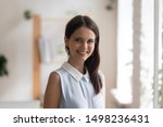 Headshot profile picture of confident young woman bank specialist or coach stand looking smiling at camera, happy positive millennial female employee or worker posing making photo, shooting for album