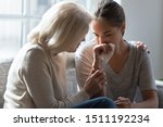 Loving elderly mother hug crying millennial daughter show support and care after relationships breakup, supportive senior 60 woman embrace cuddle grownup child feeling depressed, having life problems