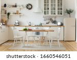 Small photo of Interior design or bright white modern kitchen, fresh vegetables fruit wooden table, empty renovated furnished studio or flat apartment for rent, mortgage, real estate, renovation service concept