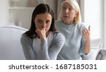 Small photo of Mad bothered millennial girl annoyed by authoritative lecturing senior mother scolding quarreling, pensive distressed grown-up adult daughter ignore angry mature mom talking, generation gap concept
