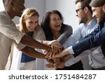 Small photo of Close up image overjoyed 5 multi ethnic business people stack touch arms palms together celebrating promotion reward, succeed common aim. Give high five symbol of unity, team building activity concept