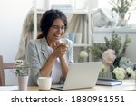Great. Laughing young female florist decorator engaged in remote working from home office studio. Enterpreneur designer reading good news on laptop screen getting loan approval on business development