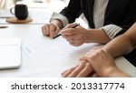 Small photo of Hands of elderly female client, mature business leader, senior businesswoman reading and signing contract with assist of lawyer, solicitor. Executive checking legal document for affixing signature