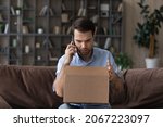 Small photo of Stressed male client arguing with internet store manager, feeling dissatisfied with received item or crashed goods in carton box, complaining about awful shipping service, negative shopping experience