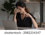 Small photo of Sudden eye pain. Tired overworked latin woman office employee wince rub nose take spectacles off feel headache eye strain dizziness. Fatigue young female overloaded by computer work has vision problem