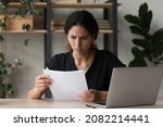 Small photo of Worried unhappy latin businesswoman enterpreneur read paper letter about loan credit denial unexpected debt tax overdue. Stressed troubled woman employee thinking on business problem in bank notice