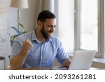 Small photo of Overjoyed laughing young man looking at computer screen, celebrating getting email with amazing good news, reading online lottery gambling giveaway win notification, making successful profitable deal.