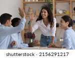 Small photo of Happy excited two employees giving high five, celebrating team success, work achieve, sales result, thanking for successful idea, completing project, enjoying teamwork together