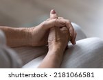 Small photo of Clasped hands on lap of nervous anxious mature 60s lady waiting for important news. Senior 70s woman keeping wrists and palms in worried position. Anxiety, body gesture concept. Close up