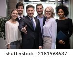 Small photo of Smiling male CEO or director pose with office team stretch hand get acquainted greet with new employee. Happy businessman meet welcome newcomer newbie at workplace. Recruitment, acquaintance concept.