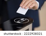 Small photo of Close up shot unrecognizable authorized person, businessman in formal suit swipe pass card to electronic card reader passing security system checkpoint in modern office area before working day start
