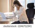 Small photo of Businesswoman sitting at desk having unpleasant conversation on cell phone, looks frustrated listen bad news about business failure, personal concerns, unsuccessful results of work. Workload, problems