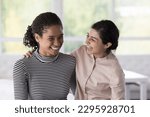 Small photo of Two cheerful multiracial women, Indian and African best friends, hugging, laughing spend time together enjoy communication and good, friendly relationship. Interracial friendship, companionship, amity