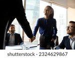 Small photo of Smiling diverse businesspeople handshake close deal or make agreement at meeting with clients. Happy business partners shake hands get acquainted greet at briefing. Employment, acquaintance concept.