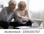 Small photo of Shocked upset retired older couple counting overspent budget, feeling frustrated, stressed about money loss, financial problems, bankruptcy, using calculator, laptop at paper bills