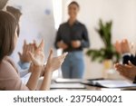 Small photo of Inspired motivated business audience applauding coach after successful presentation, thanking leader for meeting, collaboration, motivation, giving positive feedback