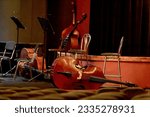 Small photo of The image of four double basses lie on the stage of the theater during the intermission