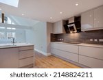 Small photo of Trumpington, Cambridgeshire, England - September 1 2017: Modern refitted kitchen with high gloss units and built in appliances