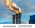 Burning gas torch with thick poisonous smoke. Gas processing and oil refinery. Air pollution! Exhaust gases, ozone depletion, greenhouse effect. 