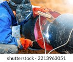 A Welder In A Protective Mask...
