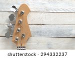 Electric Bass Guitar, against a white wooden background. Editor's view. Wide copy space for editor's text.