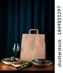 Small photo of daily meals and snacks. Diet nutrition and brown paper bag package with copy space, Healthy food delivery from a restaurant, delicious food on the background of a paper bag package