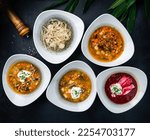 Small photo of Traditional Polish, Russian and Ukrainian soups. Set of soups from the restaurant menu: cucumber soup, mushroom soup, beetroot soup (borscht), soup with noodles and pork meatballs.
