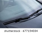 close-up car windshield rain wipers, rainy weather and vehicles concept