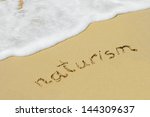 Concept or conceptual hand made or handwritten text in sand on a beach in an exotic island,for  summer,ocean,sea,travel,vacation,tourism,tropical,naturism,nudism,message,resort,paradise,sunny or water