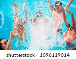Small photo of Cropped close up shot of youth going crazy in the pool, splitting water and go insane, huge splashes of blue clear water, guys jump and dabble ladies, they scream and laugh