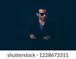 Small photo of Portrait of he nice cute lovely well-groomed self-content handsome attractive classy elegant man in blazer suit eyewear looking aside isolated over dark black background