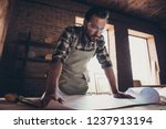 Small photo of Cabinetmaker handy handicraftsman design designer people person concept. Low angle close up view photo portrait of thoughtful smart pensive professional handsome guy looking plan on table-top desktop