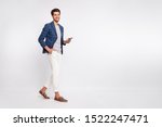 Small photo of Full length body size view of nice attractive stylish trendy luxury cheerful cheery businessman wearing blue checked blazer using cell reading news feed isolated over light white pastel background