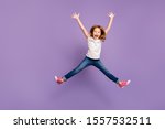 Full length photo of funny small foxy lady jumping high rejoicing making star shape in air cheerful crazy mood wear casual t-shirt jeans isolated purple background