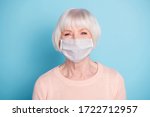 Small photo of Closeup portrait of nice-looking attractive groomed confident cheery healthy gray haired lady wear sweater respiratory mask stay safe isolated blue pastel background