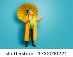 Small photo of Full length body size view of his he nice dreamy cheerful cheery grey-haired man wearing yellow topcoat expecting sun sunny day isolated over bright vivid shine vibrant blue color background