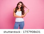 Small photo of Photo of funny pretty wavy lady wind curl around finger showing perfect groomed hairstyle after treatment procedure wear white casual tank-top jeans isolated pink color background