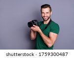 Portrait of cheerful man paparazzi hold dslr camera have spring free time holiday wear good look copyspace outfit isolated over grey color background