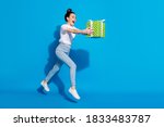 Full length profile side photo crazy girl jump hold green gift box run want give dream package friend 14-ferbuary 8-march holiday wear white t-shirt isolated bright shine color background
