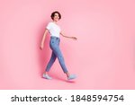 Full length body size profile side view of nice cheerful cheery brown-haired girl wearing comfy clothes walking isolated over pink color background